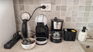 a kitchen counter with a coffee maker and a blender at Central Modern View- unitate autorizată de Ministerul Turismului in Râmnicu Vâlcea +30 photos
