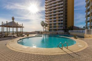a swimming pool with a gazebo and a building at Summer House 1105A in Orange Beach