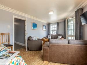 a living room with a couch and two chairs at 3 Bed in Croyde 87752 in Croyde