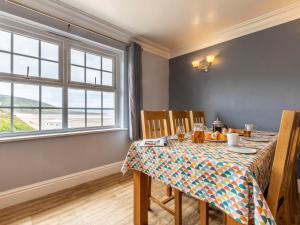 a dining room with a table and a window at 3 Bed in Croyde 87752 in Croyde