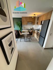 a kitchen and living room with a table and chairs at NUEVO E IMPECABLE A PASOS DEL MAR in Antofagasta