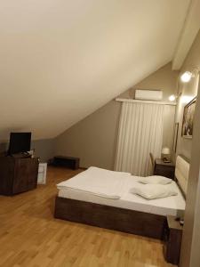 a bedroom with a large bed in a attic at soprano guest house in Baku
