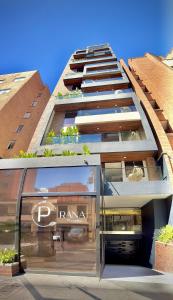 a tall building with a sign on the side of it at Luxury Suites Prana By Cadissa in Medellín