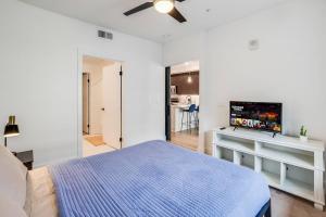 a bedroom with a bed and a flat screen tv at Hollywood Walk of Fame! 1BD Pool/Parking/Balcony in Los Angeles