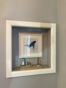 a picture of a blue bird in a frame on a wall at Cosy 2 Bed Chalet in Great Yarmouth