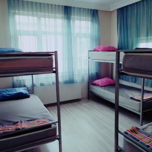 a room with three bunk beds and a window at Eroz Hostel Old City in Istanbul