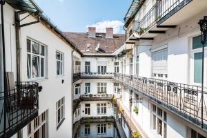 a row of white buildings with balconies at Dohány Street Delight in Budapest