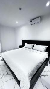 a bedroom with a large white bed in a room at MantaSurf Hotel in Tarqui