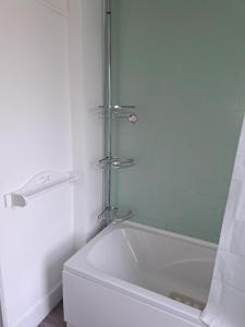 a white bath tub in a bathroom with a shower at Double Room available- London Seven Kings Seven Kings Train Station in Seven Kings