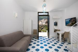 a living room with a couch and a table at YourHome - H2O Marina Apt Sea View in Positano