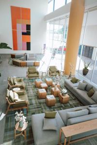 a lobby with couches and tables in a building at Gran Hotel Concordia in Irapuato
