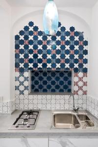 a kitchen with an american flag wall above a sink at YourHome - H2O Marina Apt Sea View in Positano +11 photos