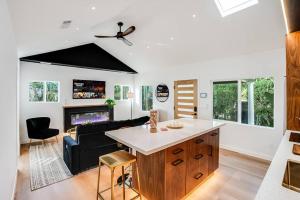 a kitchen and living room with a table and a couch at Private Gated 3 BD - 3 BR Modern Home in Los Angeles