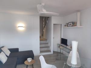 a living room with a couch and a table at Des Artistes Son Parc in Son Parc