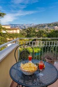 a table with a bowl of food and two drinks on a balcony at L'Arancio house- Perfect for families and groups in Sorrento
