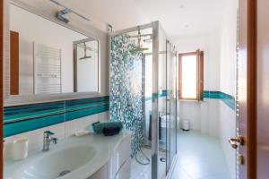 a bathroom with a sink and a shower with a mirror at L'Arancio house- Perfect for families and groups in Sorrento +22 photos