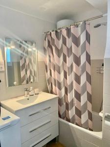 a bathroom with a sink and a shower curtain at Cozy apartment Playa Levante in Santa Pola