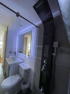 a bathroom with a shower with a toilet and a sink at Apto excelente Ubicación Bogotá in Bogotá