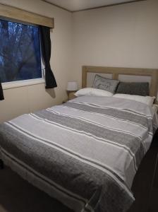 a large bed in a bedroom with a window at Swanns retreat in Tattershall