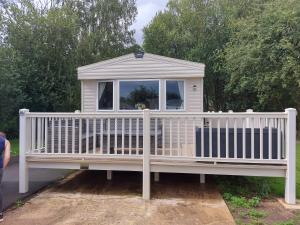 a white gazebo sitting on top of a porch at Swanns retreat in Tattershall