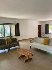 a living room with two couches and a coffee table at The ranch apartments, en-suite rooms in Lusaka