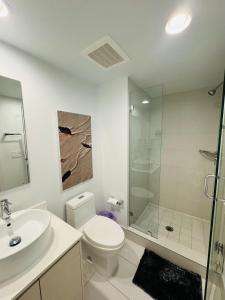 a white bathroom with a toilet and a shower at Lovely 2Bed 1Bath Condo With Private Balcony 18th Floor in Hallandale Beach