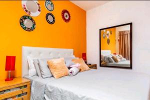 a bedroom with a white bed and a mirror at Oasis Munro in Munro