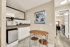 a small kitchen with a table and a microwave at Scottish Fairway Inn in Monterey