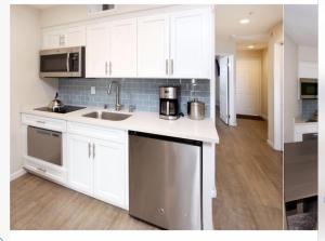 a kitchen with white cabinets and a sink and appliances at Seascape Resort Aptos, Capitola, Santa Cruz in Aptos