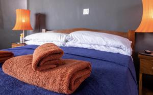 a bedroom with a bed with a towel on it at Room - Sleeps 3 - Balcony - Pool - Parking in Bakau +9 photos