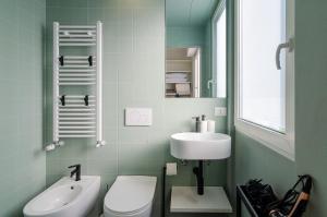 a bathroom with a toilet and a sink at SAN SIRO BLUE FLAT in Milan