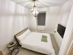 מיטה או מיטות בחדר ב-Soho Apartments
