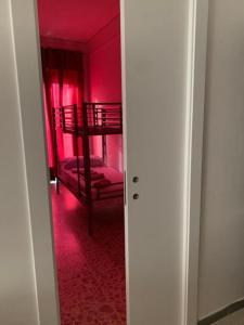 a room with pink walls and a room with bunk beds at Gargano Home in Vieste