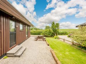 a patio with a picnic table next to a house at 3 Bed in Ullswater 88212 in Tirril