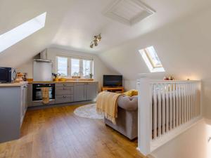 a living room with a couch and a kitchen at 1 Bed in Hereford 83703 in Wormbridge