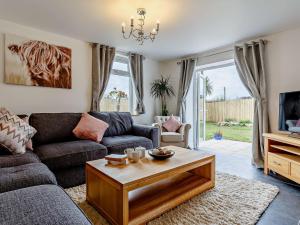 a living room with a couch and a coffee table at 4 Bed in Looe 82227 in Saint Cleer