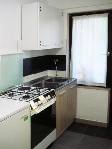 a kitchen with a stove and a sink at Studio Apartment ''k'' in Pula