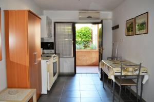 a kitchen with a table and a dining room at Studio Apartment ''k'' in Pula
