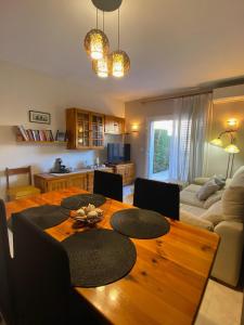uma sala de estar com uma mesa de madeira e uma sala de jantar em Casa Sobrestany L’Estartit em L'Estartit