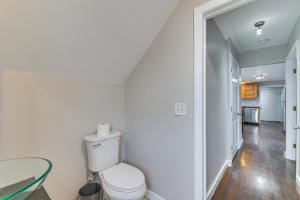 a bathroom with a toilet and a glass table at Pet-Friendly Malden Apartment 7 Mi to Boston! in Malden
