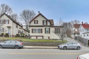 two cars parked in front of a house at Pet-Friendly Malden Apartment 7 Mi to Boston! in Malden