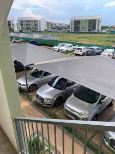 a group of cars parked in a parking lot at Stylish space Green Creek Estate next to The Blyde in Pretoria