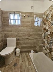 a bathroom with a toilet and a shower and a tub at Casa Albufeira in Albufeira +59 photos