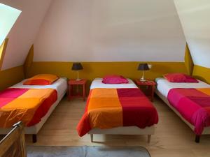 two beds with colorful sheets in a room at La Sautie in Bars +25 photos