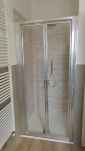 a shower with a glass door in a bathroom at BOLOESTHOUSE in Bologna