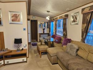 a living room with a couch and a table at 10 min walk to South Devon beach in Paignton