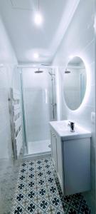 a bathroom with a shower and a sink and a mirror at 4 couchages Front de Mer Clim Parking privatif Wifi in Nice