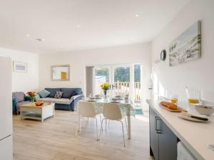 a kitchen and living room with a table and chairs at 2 Bed in Portreath 88826 in Camborne