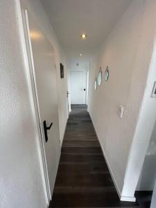 a hallway with white walls and a white door at Central Ferienwohnung in Bad Saulgau