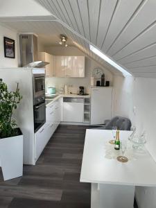 a kitchen with white appliances and a white table at Central Ferienwohnung in Bad Saulgau